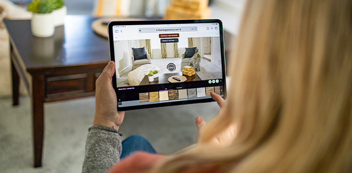 woman looking at flooring samples on tablet